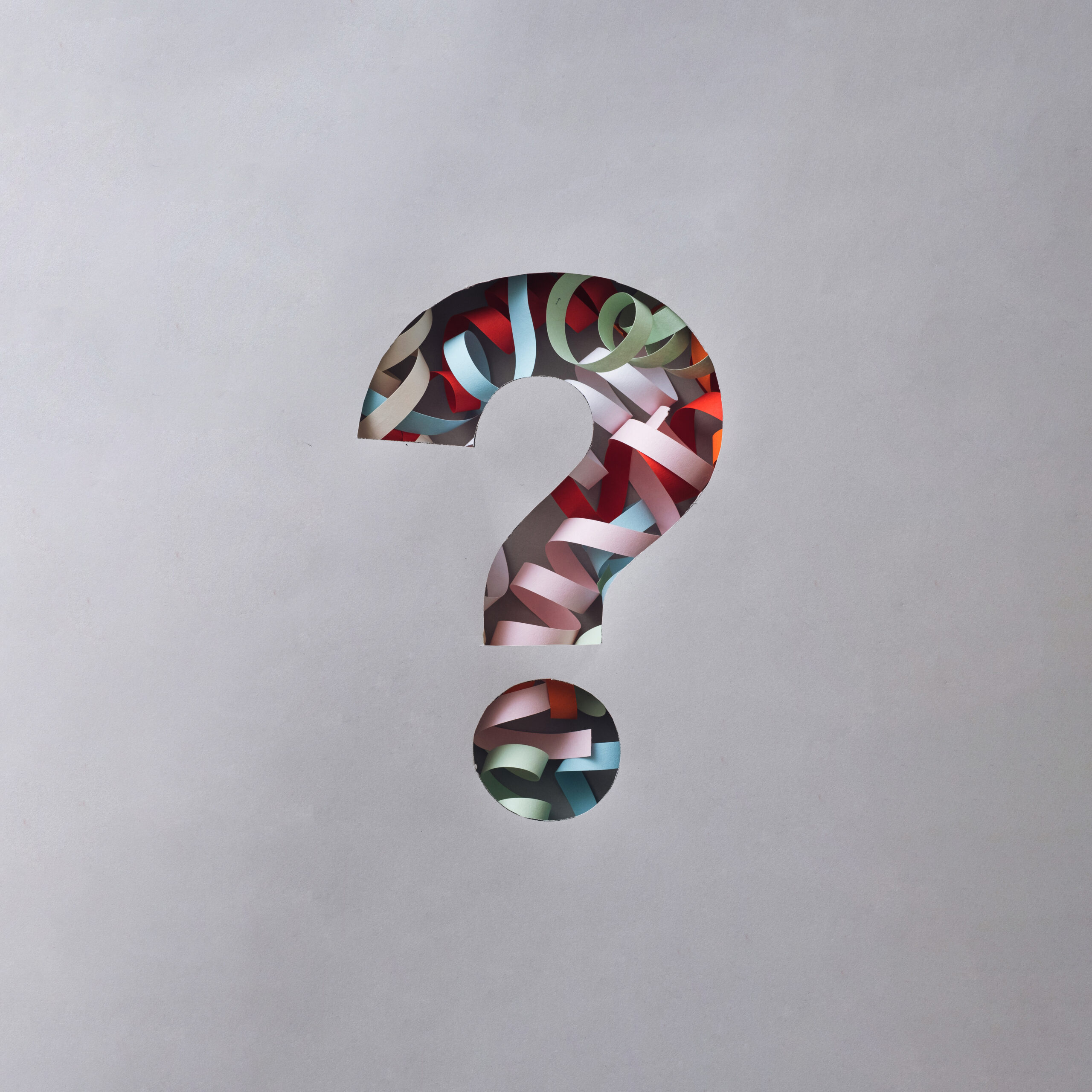Question mark filled with colorful paper confetti.