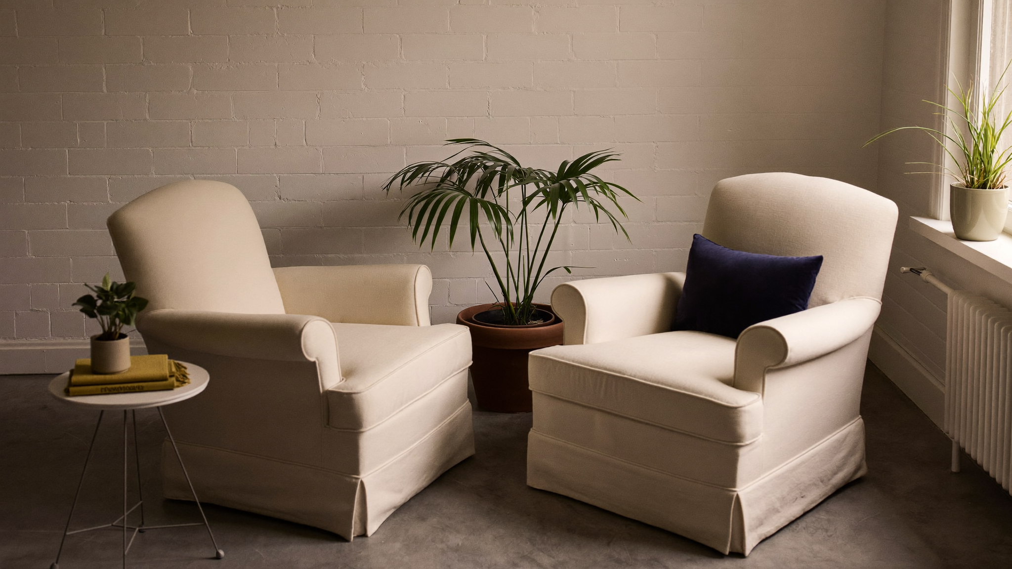 Two armchairs facing each other in a calm counselling room