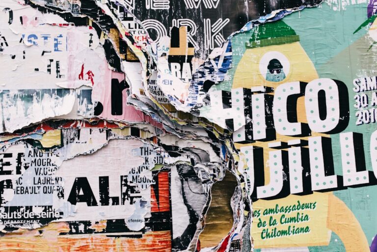 Torn street posters with "Chico Jillo" and other text visible. Layered, textured urban art.